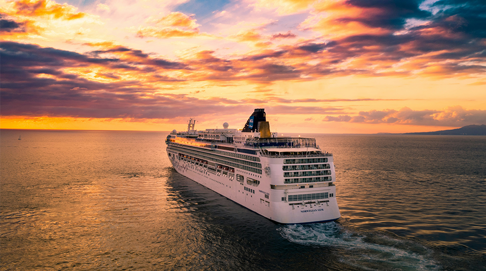 Cruise ship out at sea at sunset